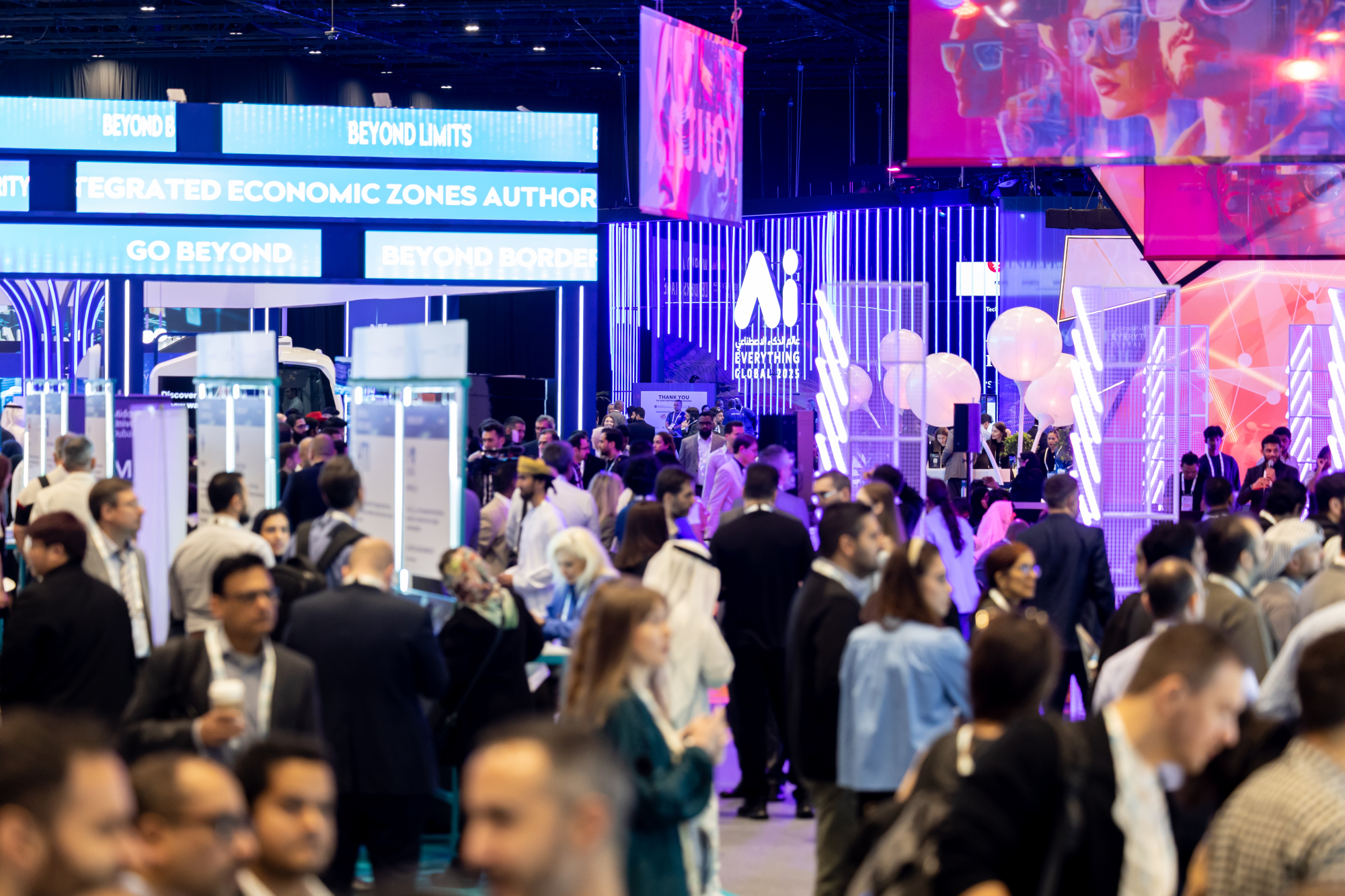 Delegates gathered between brightly lit exhibition stands in the Ai Everything halls, with AI branding overhead