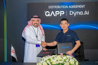 Ahmed Al Azmah of GAPP and Carlton Liew of Dyna.Ai shake hands in front of a screen reading Distribution Agreement, marking their Saudi Arabia AI partnership
