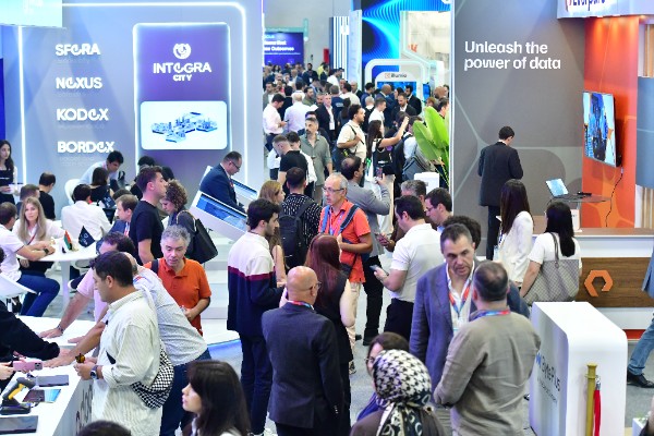 Delegates at the Integra City stand beside an Unleash the power of data display at GITEX Ai Türkiye